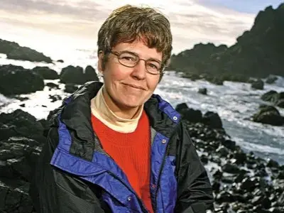 portrait of Jane Lubchenco on a rocky shoreline